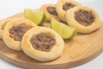 Arabic Meat sfiha over a wooden table.