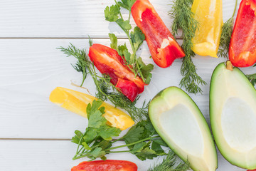 Fresh organic vegetables, cherry tomatoes, avocado, cucumbers, carrot, red and yellow pepper, green. Vegan food, healthy lifestyle concept