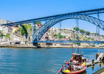 Obraz premium Famous steel bridge dom Luis above connects Old town Porto with Vila Nova de Gaia at river Douro, Portugal.