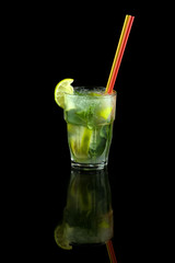 mojito cocktail with lime, mint leaves and ice cubes, refreshing summer drink with a straw, over black background