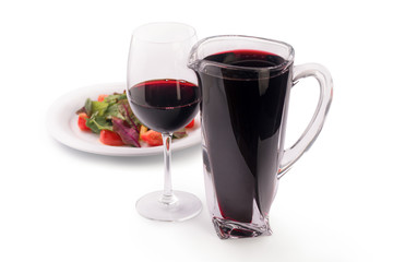 red wine sangria pitcher and salad with lettuce and tomato, isolated on white background