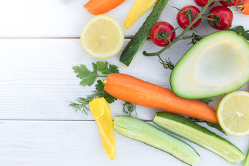 Fresh organic vegetables, cherry tomatoes, avocado, cucumbers, carrot, red and yellow pepper, green. Vegan food, healthy lifestyle concept