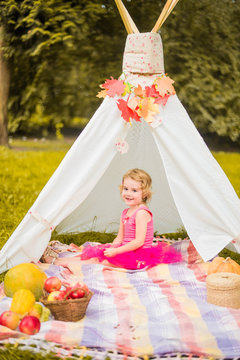small girl smailling on autumn picnic