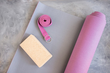 .Open yoga mat with cork  block and yoga belt. Yoga practice props background. Copy space..