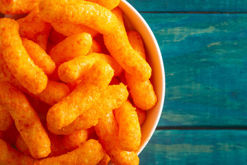 Orange Cheddar Cheese Puffs on a Wood Table