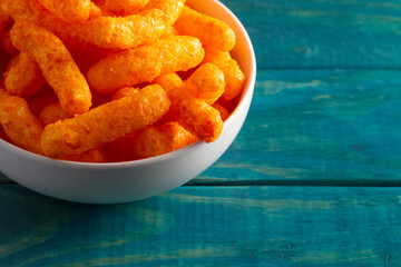 Orange Cheddar Cheese Puffs on a Wood Table