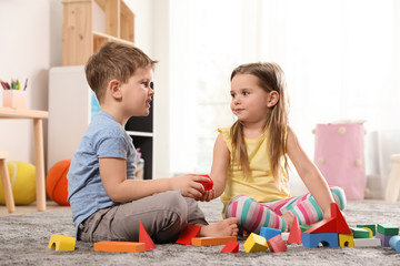 Obraz premium Little children playing with colorful blocks indoors