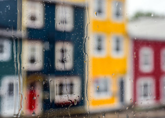 Rain drops on windows with jellybean houses in St. John's, Newfoundland