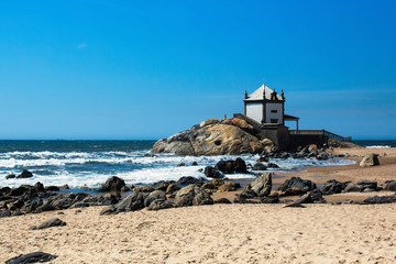 Fototapeta na wymiar Chapel Senhor da Pedra on Miramar Beach, Vila Nova de Gaia, Portugal.