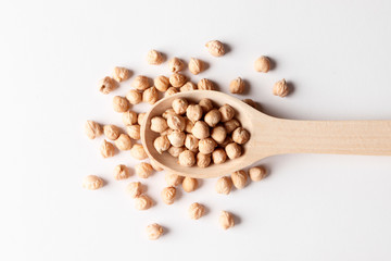 Chickpea in a wooden spoon isolated on white background