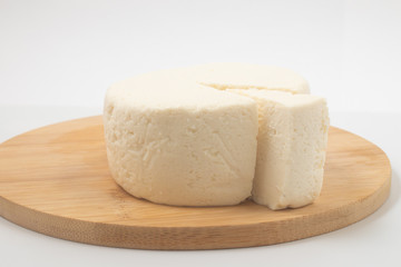 Slice of Ricotta Cheese over a wooden board