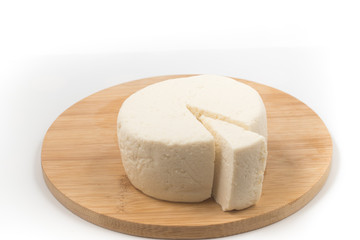 Slice of Ricotta Cheese over a wooden board