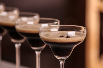 Glasses of delicious Espresso Martini on blurred background. Alcohol cocktail