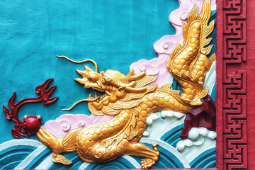 Colorful sculpture of a dragon on the wall of the Zhaojue Temple.