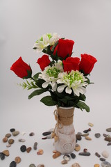 Clay vase with red roses