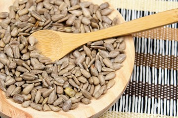 Round wooden board with sunflower seeds