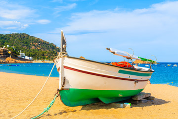 Fishing boat on golden sand beach, Tossa de Mar, Costa Brava, Spain