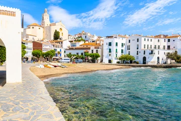 Washable wall murals Mediterranean Europe White houses and blue sea in Cadaques port with church and beach, Costa Brava, Spain