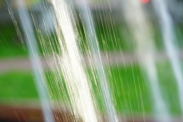 abstract background water drops fountain splashes glare from summer sun