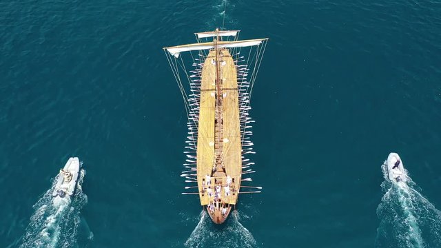 Aerial drone video of Ancient Greek warship full scale replica Trireme arriving in port of Faliro, Attica, Greece