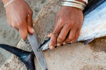 woman filleting fresh caught fish