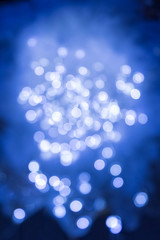 Blurry festive lights with a blue color and a beautiful bokeh.