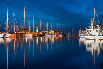 yachts in the marina, the view of the yachts and their reflection in the sea water, the dark blue...