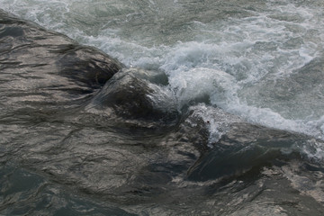 texture river creek stream. Fast flowing water in the mountain river