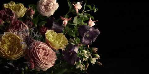 Beautiful bunch of colorful flowers on black background in vintage style.