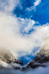 Fototapeta na wymiar Row of cablecars against cloudy sky in the Swiss Alps