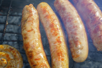 bratwurst, fried sausages on the grill