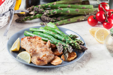 Fried cod fillet with green asparagus