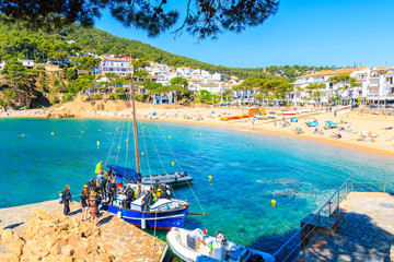 TAMARIU, SPAIN - JUN 2, 2019: Boat with divers anchoring in beautiful fishing village of Tamariu,...