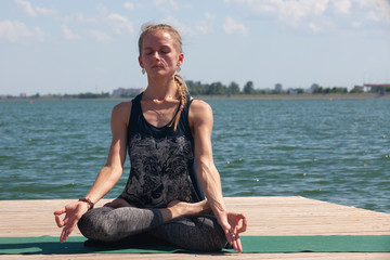 Fototapeta na wymiar Meditation. young woman sitting in the lotus position