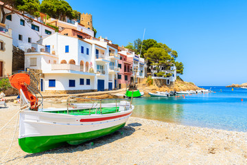 Traditional fishing boat on beach in Sa Tuna coastal village, Costa Brava, Spain