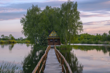 Fototapeta na wymiar Wonderful Little Fisherman House with a bridge