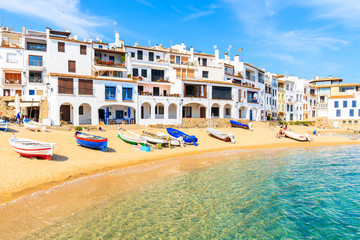 Fishing boats on beach in Calella de Palafrugell, scenic village with white houses and sandy beach with clear blue water, Costa Brava, Catalonia, Spain