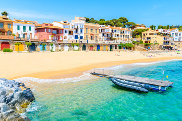 Fototapeta premium Boats on Canadell beach in Calella de Palafrugell village with colorful houses on shore, Costa Brava, Catalonia, Spain