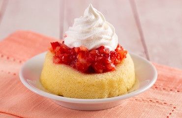A Single Serve Strawberry Shortcakes with Strawberry Sauce and Whipped Cream