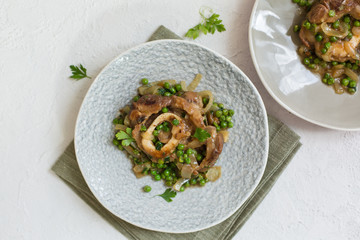 Ossobuco alla milanese - Lombard cuisine of cross-cut veal shanks, made with white wine, broth and green peas.