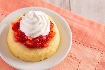 A Single Serve Strawberry Shortcakes with Strawberry Sauce and Whipped Cream