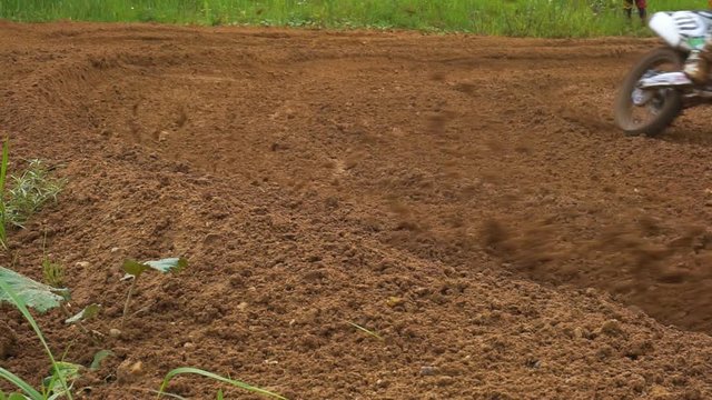 Snapshot of a professional motocross driver driving through a sharp turn.1920X1080 Full Hd.