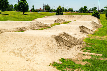 Empty dirt racing course for cycling on a clear summer day