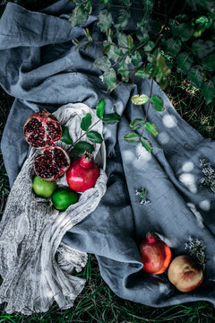 Bunch of assorted fresh fruits placed on pieces of cloth on green grass in nature