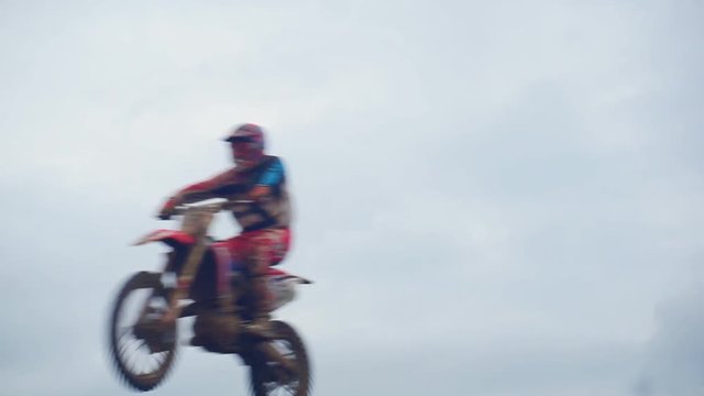 Motocross riders overcome the jump in slow motion. Jumping on a springboard.1920X1080 Full Hd.