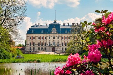 Beautiful historic castle in colorful spring scenery. Neo baroque castle in a park in Pszczyna in Poland.