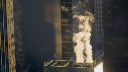 CLOSE UP: White smoke comes rolling out of building vents in New York City.