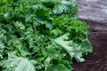 fresh kale cabbage on wooden surface