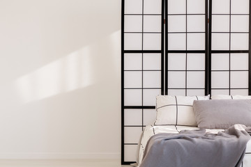 Fototapeta na wymiar Black and white bedroom design with mullions wall