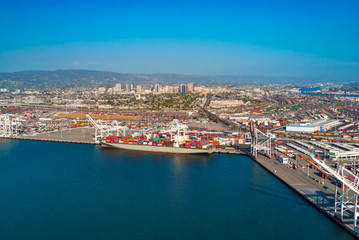 Fototapeta premium Oakland Harbor port terminal with cargo ship and shipping containers
